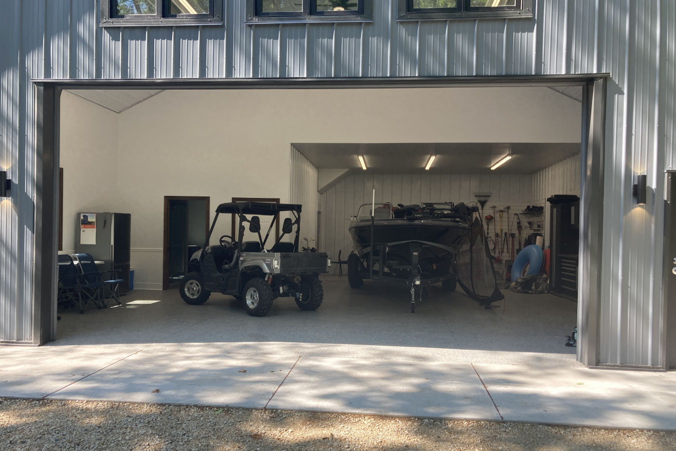 Shop with living quarters steel siding garage interior with open span and equipment storage