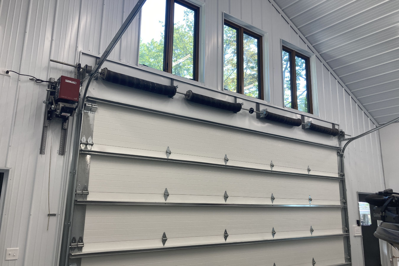 Shop with living quarters high-lift overhead garage door system with windows and opener