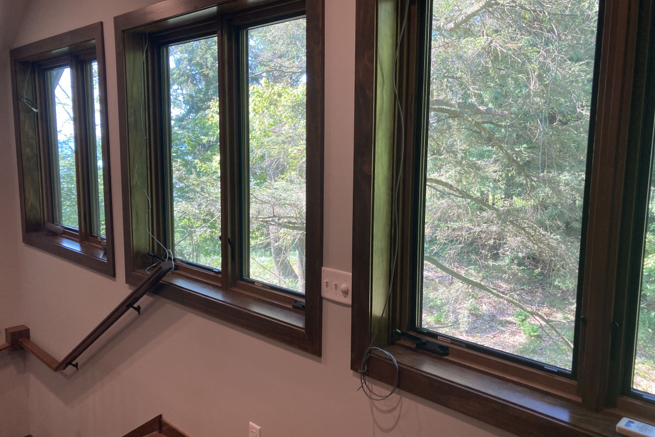 Shop with living quarters interior windows with wood trim and outdoor wooded views