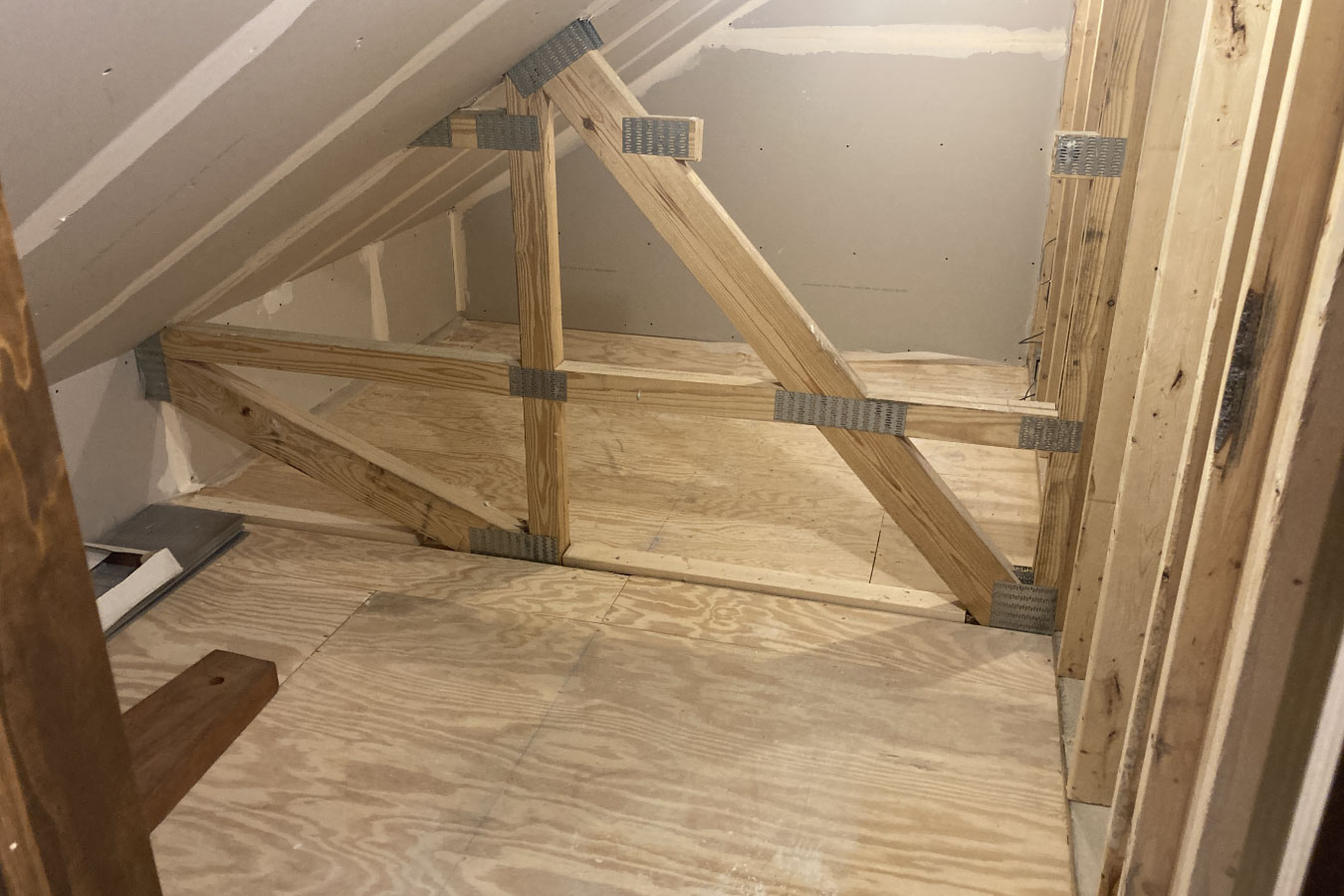 Post frame building interior showing wood truss framing and structural support system