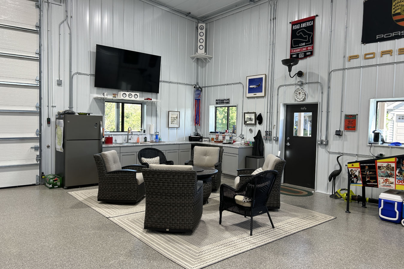 Lounge area in the Ultimate Man Cave Garage with comfortable seating and a TV for entertaining.