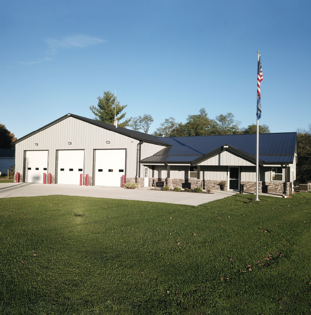 Post Frame Fire Department Station Building Fire department building with three apparatus bay doors and attached office entrance