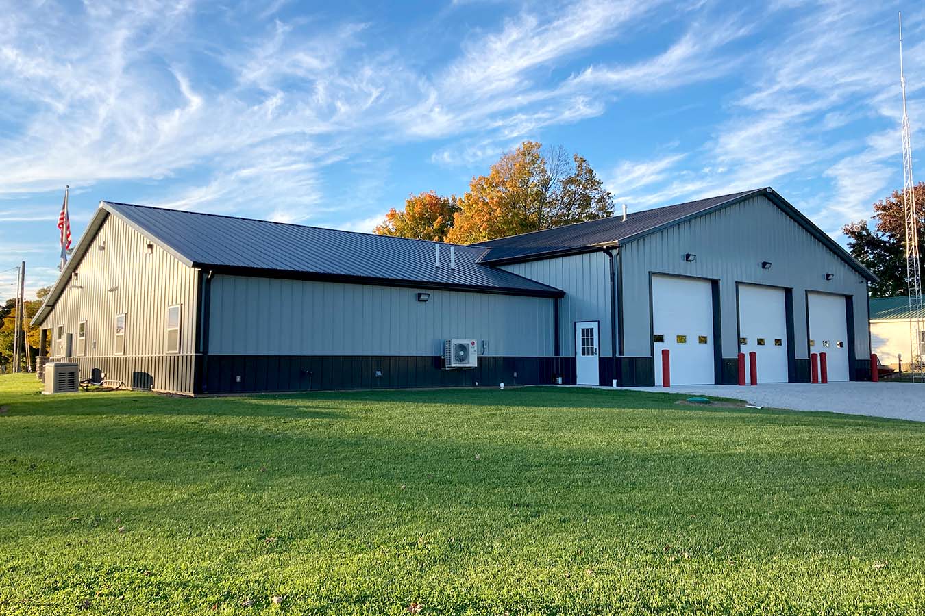 Fire department station with three apparatus bay doors and metal roof