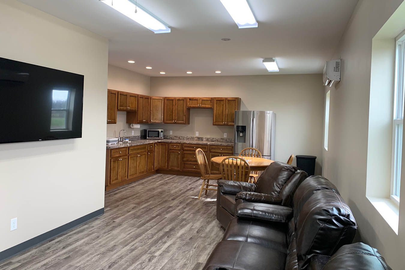 Fire station kitchen and lounge area with cabinets and seating