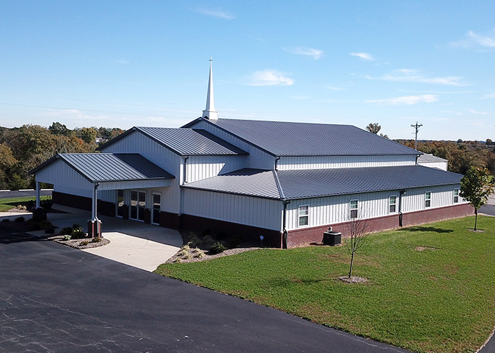 Church Building with Covered Entry and Worship Space | Walters Buildings Church building with steel siding, steeple, and covered entrance for worship and community gatherings