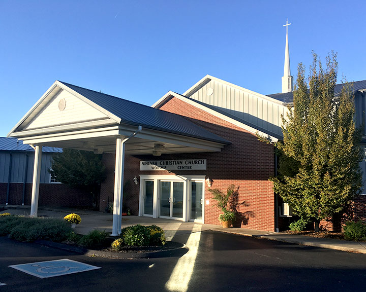 Church entrance with covered portico, steeple, and welcoming design for worship and gatherings