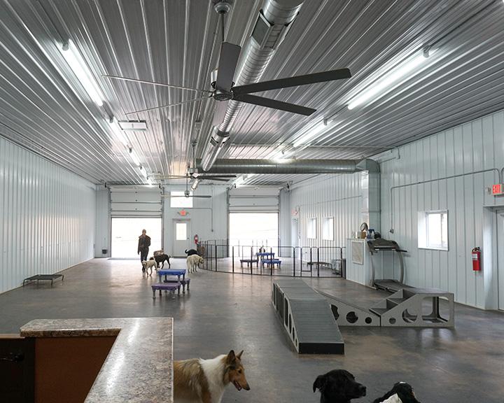 Retail service facility interior with clear-span layout, open floor space, and customer activity area