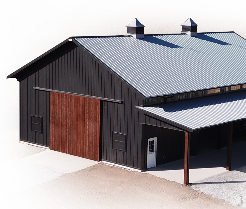 Custom Agricultural Building with Sliding Door, Cupolas, and Lean-To Porch Custom post-frame agricultural building with steel siding, sliding wood door, cupolas, and lean-to porch