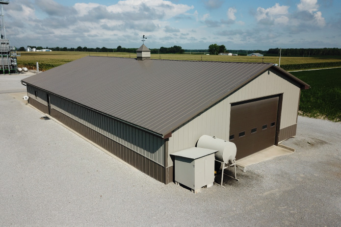 Grain Farm Pole Barn Agricultural Storage Building Aerial View Grain farm pole barn used as an agricultural storage building with overhead equipment door and wainscot