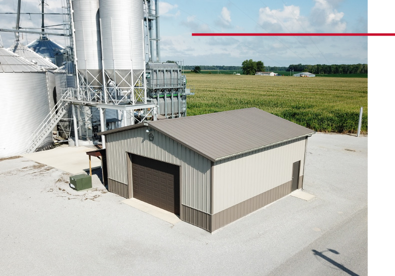 Grain Farm Pole Barn – Equipment Storage Building Grain farm pole barn storage building beside grain bins
