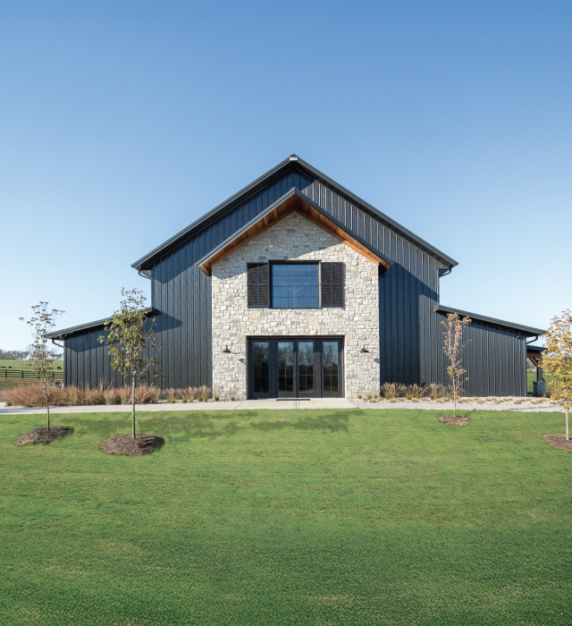Keene Ranch Event Barn | Custom Post Frame Event Barn by Walters Buildings in Versailles, Kentucky Keene Ranch event barn with black steel siding, stone front façade, large glass entry doors, and post frame construction. Kenne Ranch Event Barn in Versailles, Kentucky
