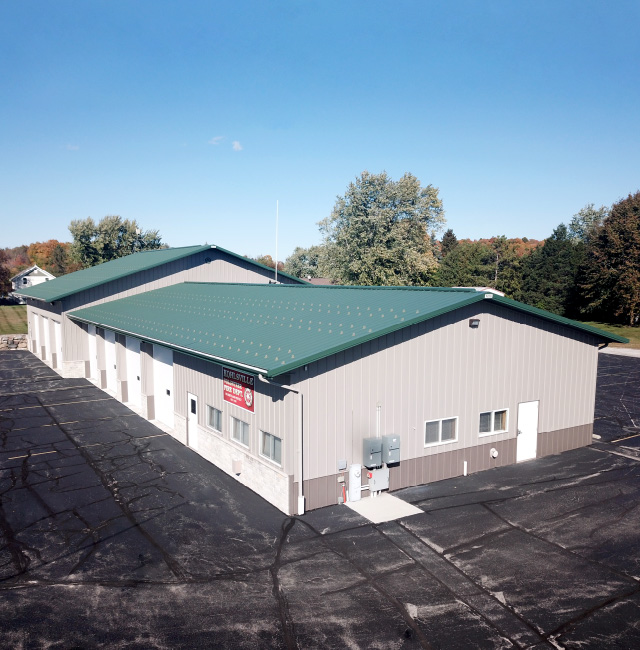 Kohlsville Fire Department Fire Station Exterior Kohlsville Fire Department post frame fire station with green metal roof and apparatus bays