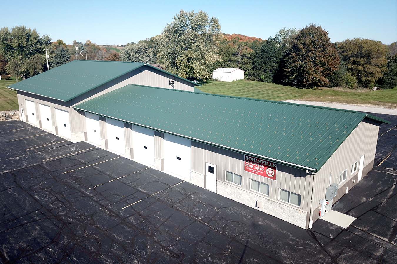95-4989 Kohlsville Fire Department post frame fire station with green metal roof and apparatus bays