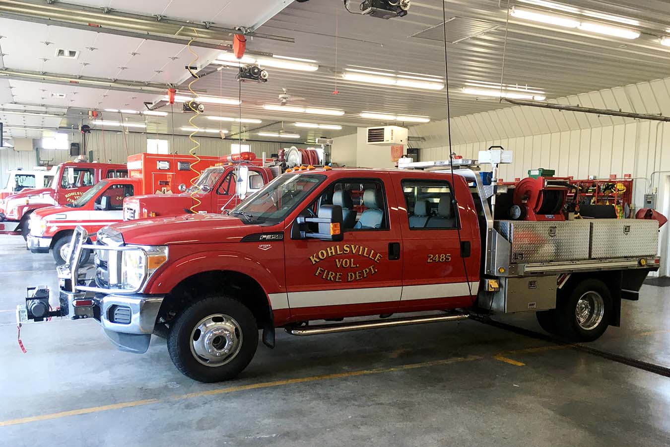 Kohlsville Fire Department fire trucks parked inside the apparatus bay of the fire station Office/Dispatch Interior with Equipment Lined Up