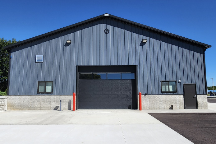 Post-Frame Auto Repair Shop Service Bay – MW Auto Repair post-frame auto repair shop rear service bay entrance with overhead garage door