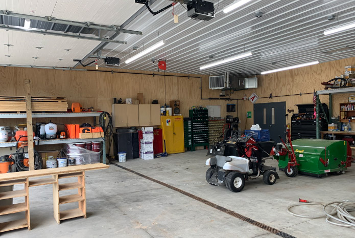 Maintenance garage workshop with equipment storage, workbench, and service area