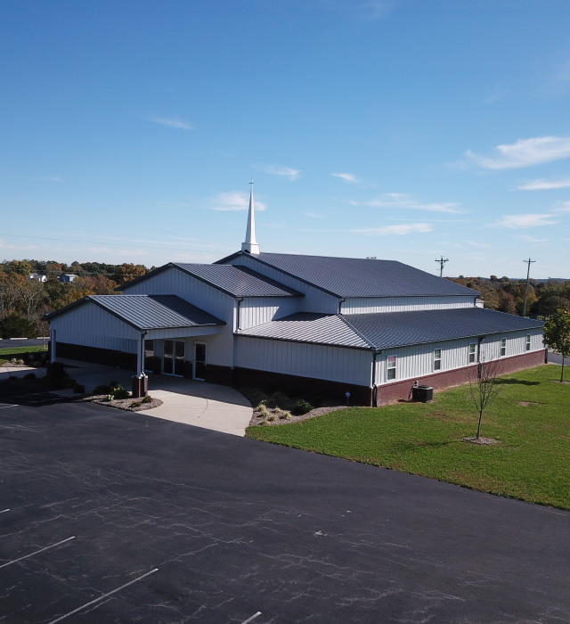 Pleasant Hill Christian Church | Post Frame Church Building Pleasant Hill Christian Church with white steel siding, gray metal roof, covered entrance, and tall steeple. in Mt. Eden, Kentucky