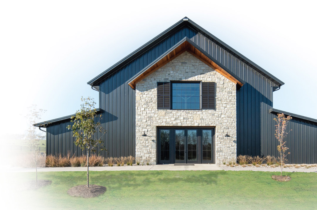 Walters Buildings post-frame structure with steel siding, stone front, and modern residential design