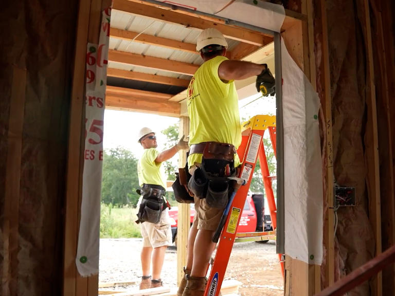 Walters Buildings Door Installation and Construction Precision Walters Buildings crew installing door frame during post-frame building construction process