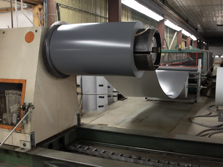 Walters Buildings Steel Manufacturing Process and Material Production Steel coil being processed in Walters Buildings in-house manufacturing facility for building materials