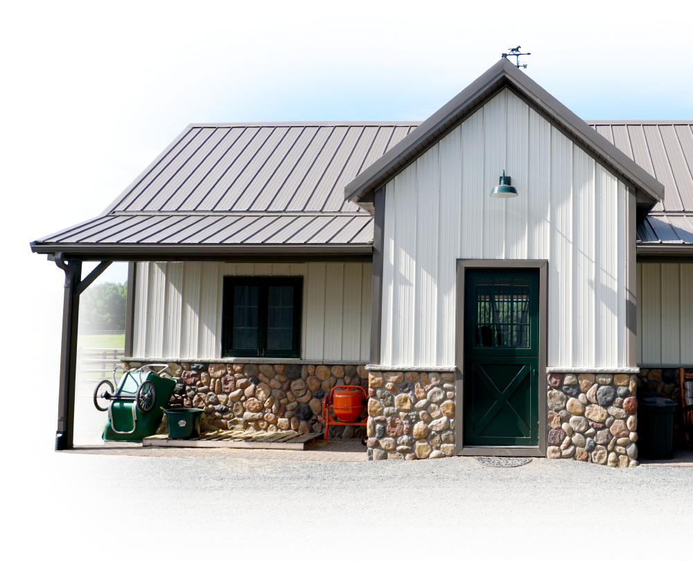 Post-Frame Building with Stone Wainscot and Covered Porch Entry Post-frame building with steel siding, stone wainscot, covered porch, and residential-style entry door