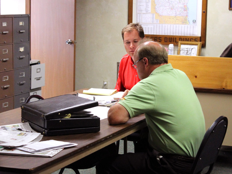 Walters Buildings Customer Consultation and Project Planning Meeting Walters Buildings team member meeting with customer to review building plans and project details