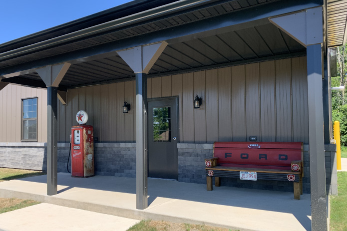Pole Barn Garage with Covered Porch | Walters Buildings covered porch on pole barn garage with stone wainscot and seating area