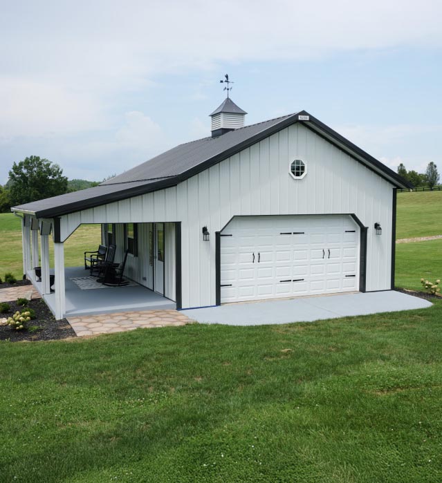 Pole Shed with Porch and Garage Door | Post Frame Building | Walters Buildings pole shed with porch, white steel siding, black trim, garage door, and cupola in Fisherville, Kentucky