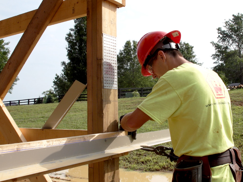 Walters Buildings crew member installing structural connection on laminated wood column