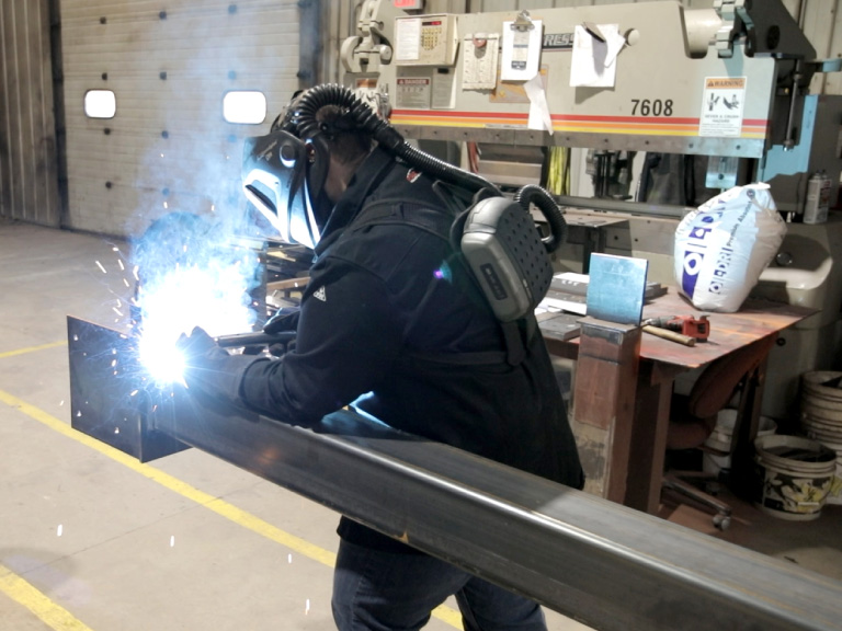 Walters Buildings welder fabricating steel components in in-house manufacturing facility