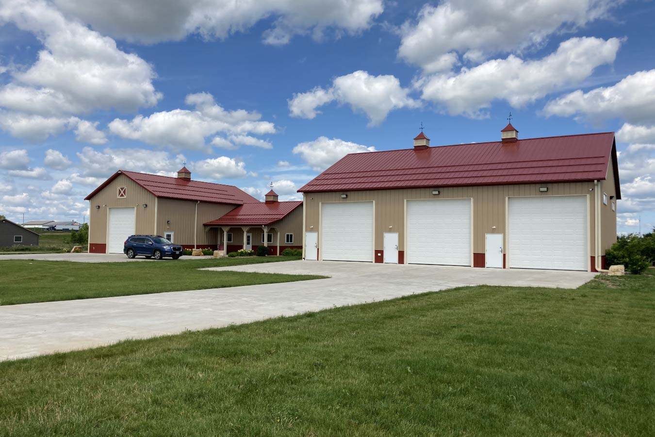 95-1138 and 95-1154 Commercial Storage Condos event barn and pole barn garage with red metal roof and multiple overhead doors