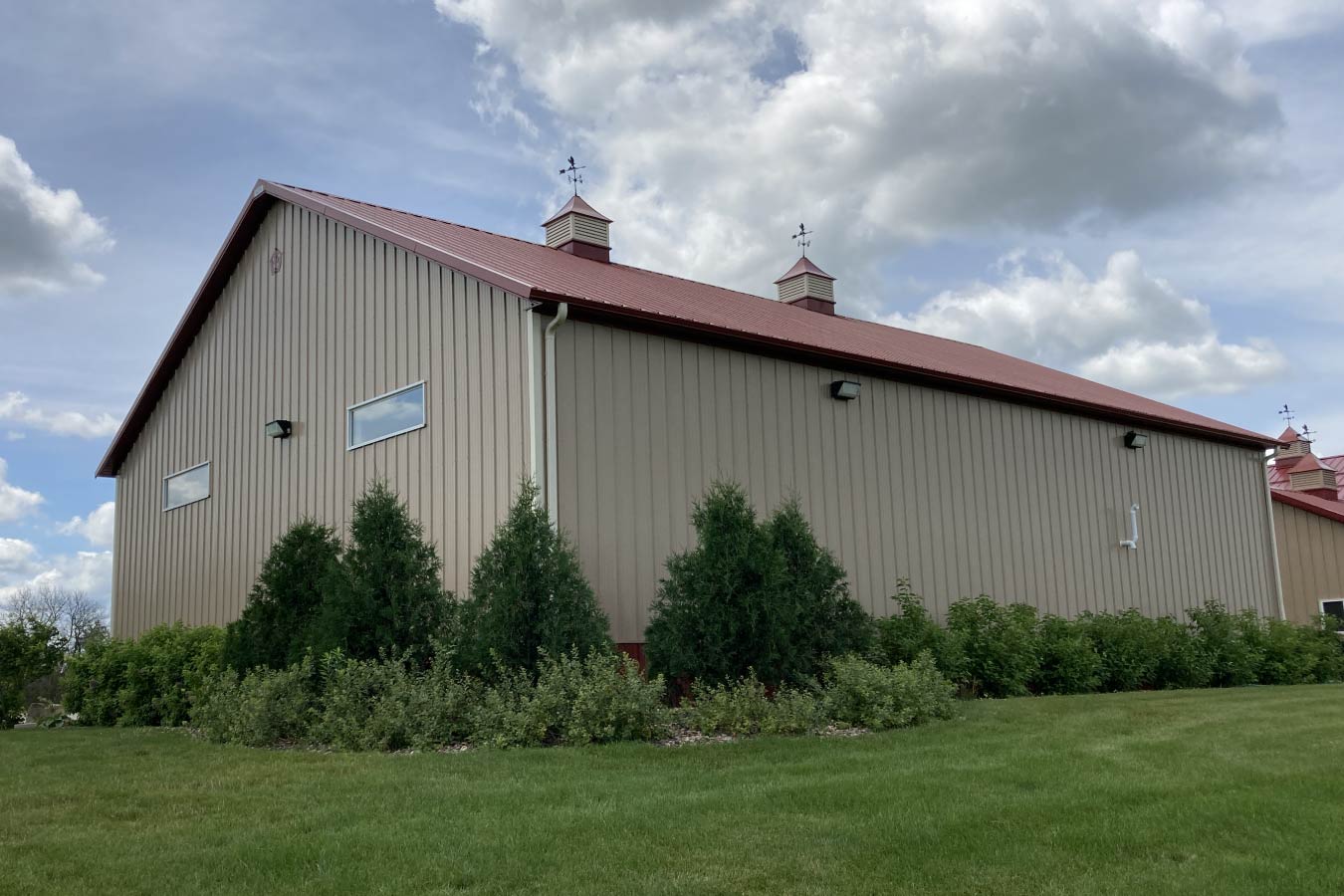 Commercial storage condo side elevation with upper windows, cupolas, and landscaped perimeter