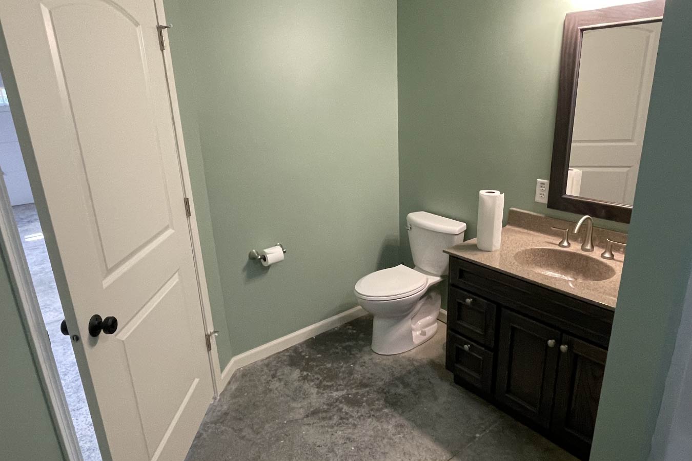 garage with living quarters bathroom featuring vanity, toilet, and modern finishes