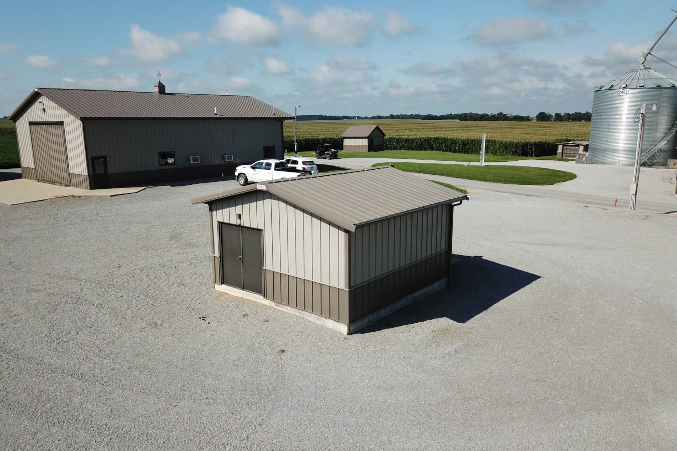 Small agricultural pole barn utility storage building located within a grain farm operation