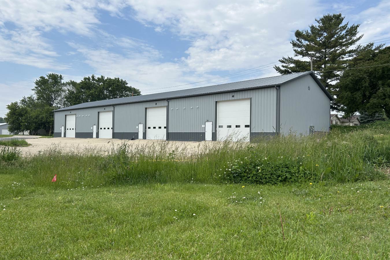 commercial business condos building with steel siding and multiple overhead doors