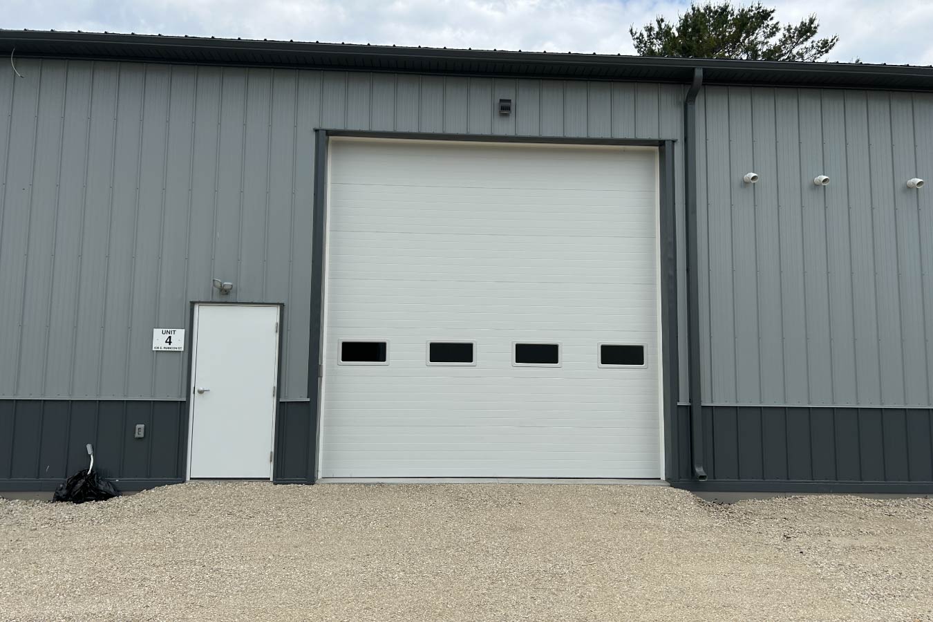 business condo unit with overhead garage door and entry door