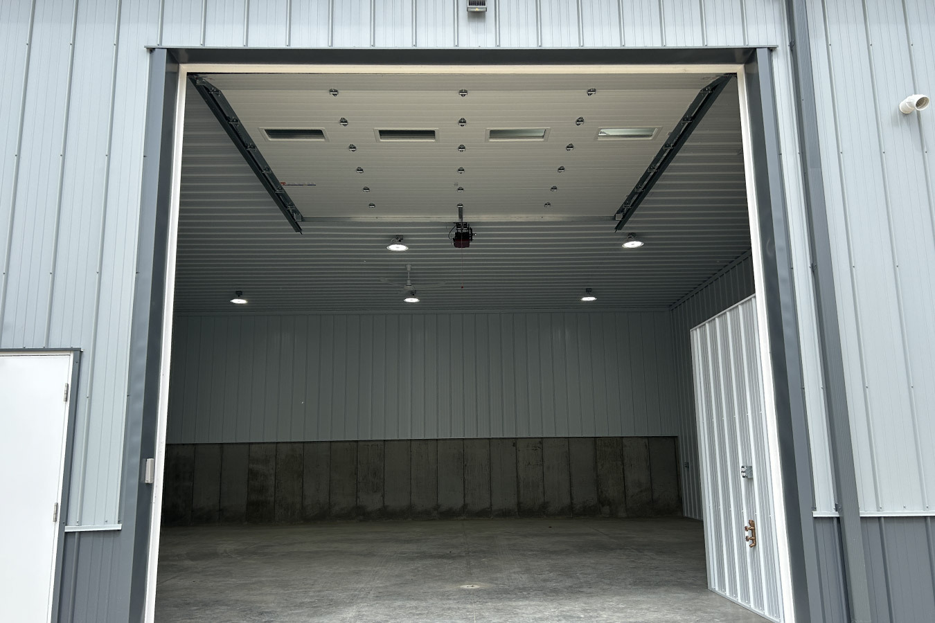 business condo unit with overhead garage door and entry door