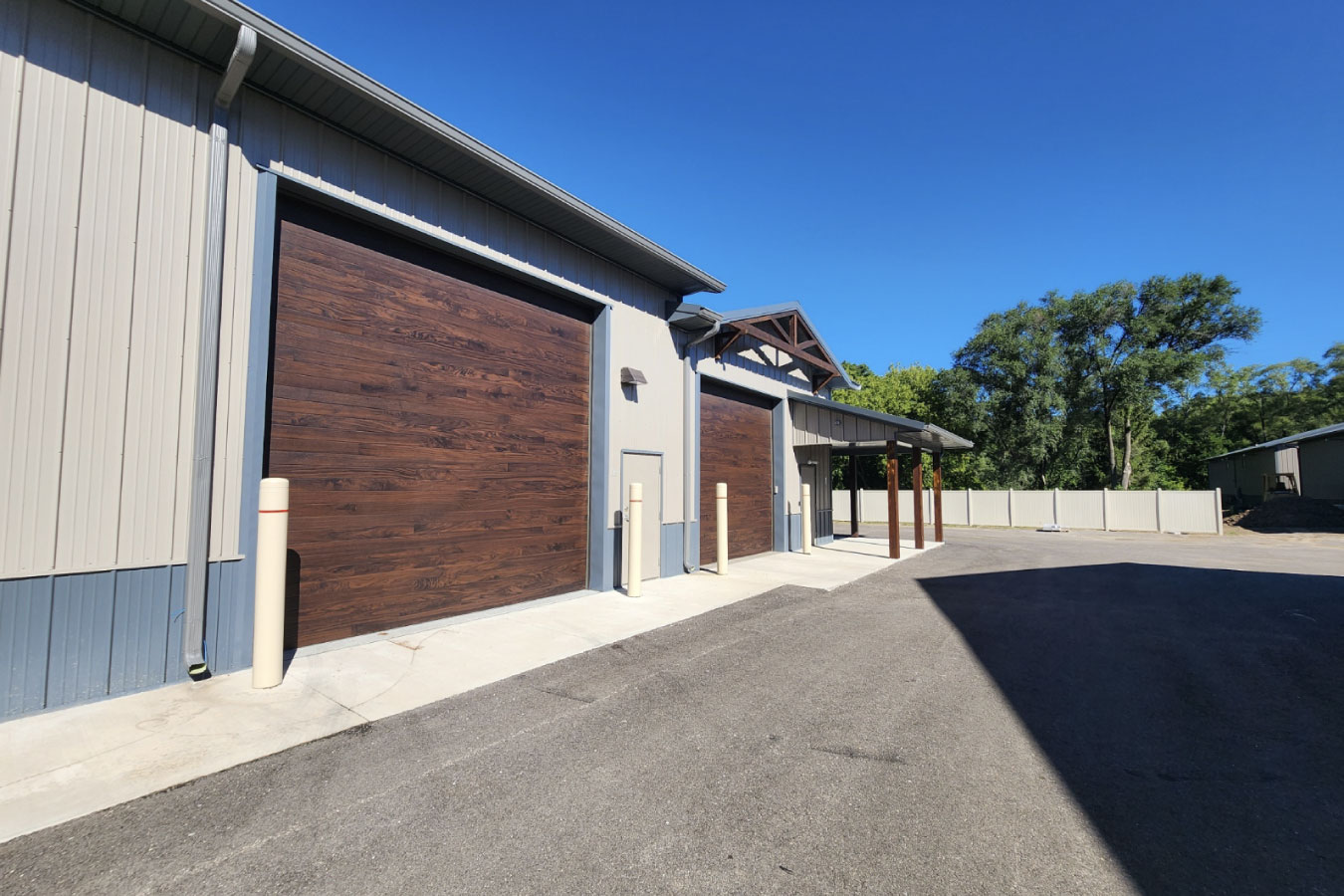 storage condominiums with large wood grain garage doors and paved access driveway