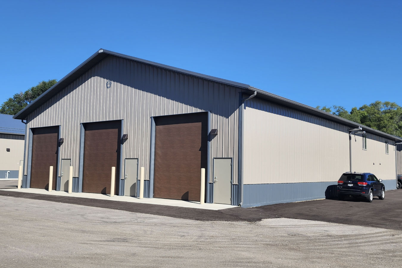 storage condominiums building with large overhead garage doors and individual unit access