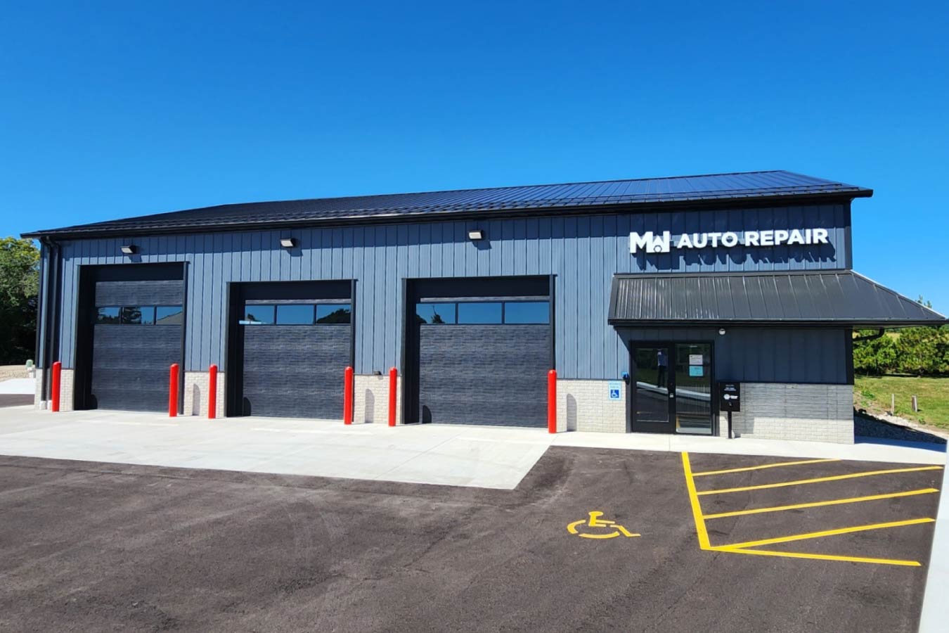 post-frame auto repair shop building with three garage service bays