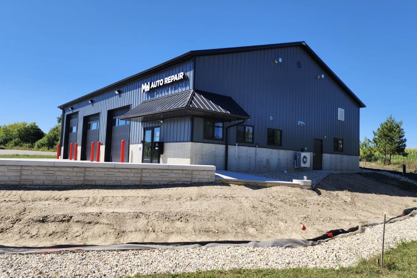 post-frame auto repair shop building with multiple garage service bays Side View