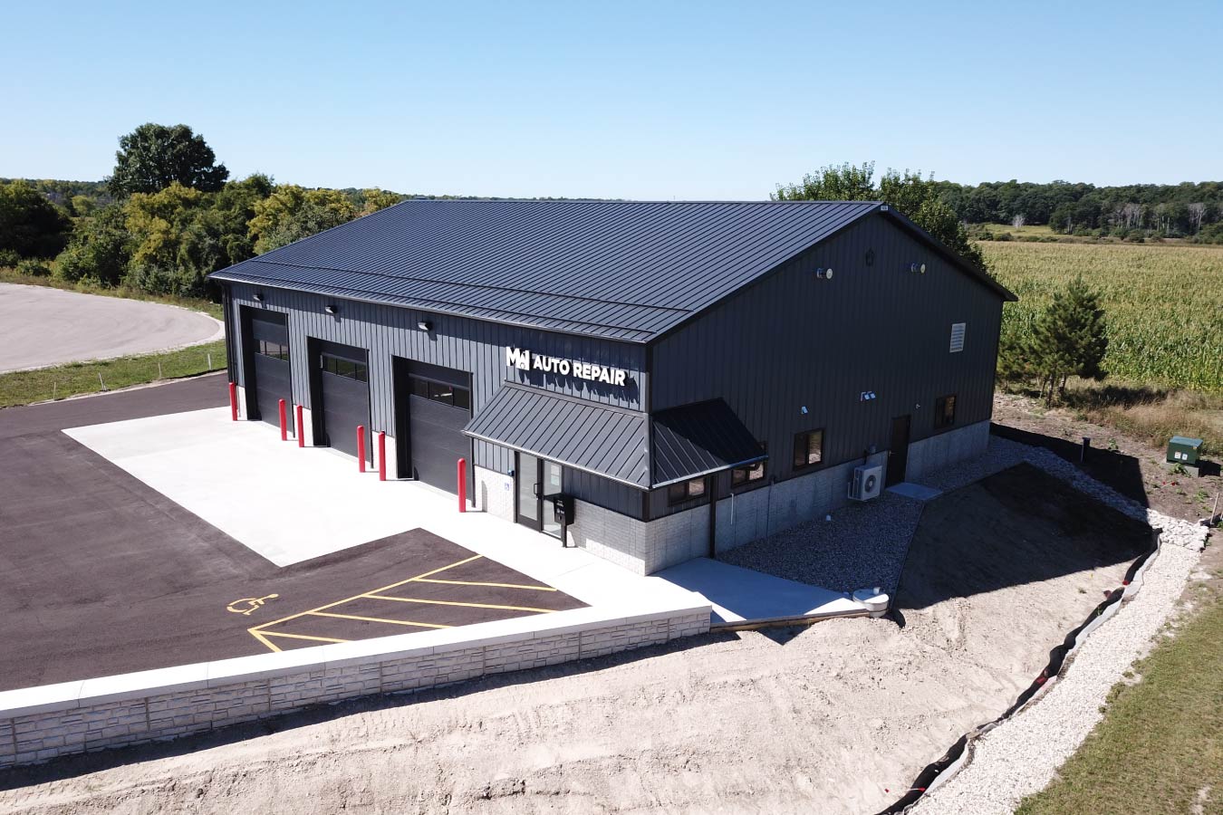 post-frame auto repair shop building with multiple overhead garage doors