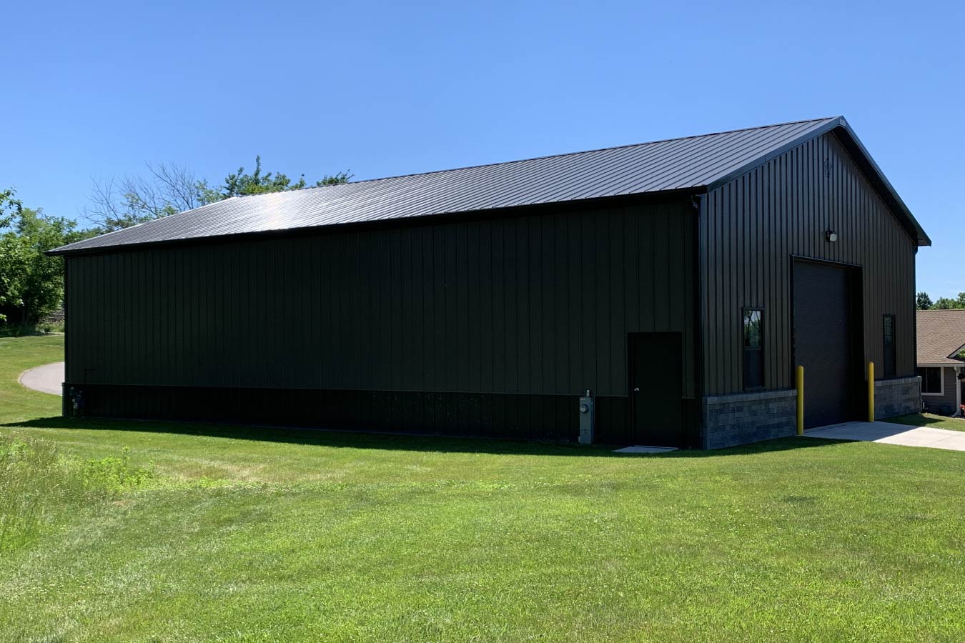 side view of pole barn garage with bronze steel siding and black trim