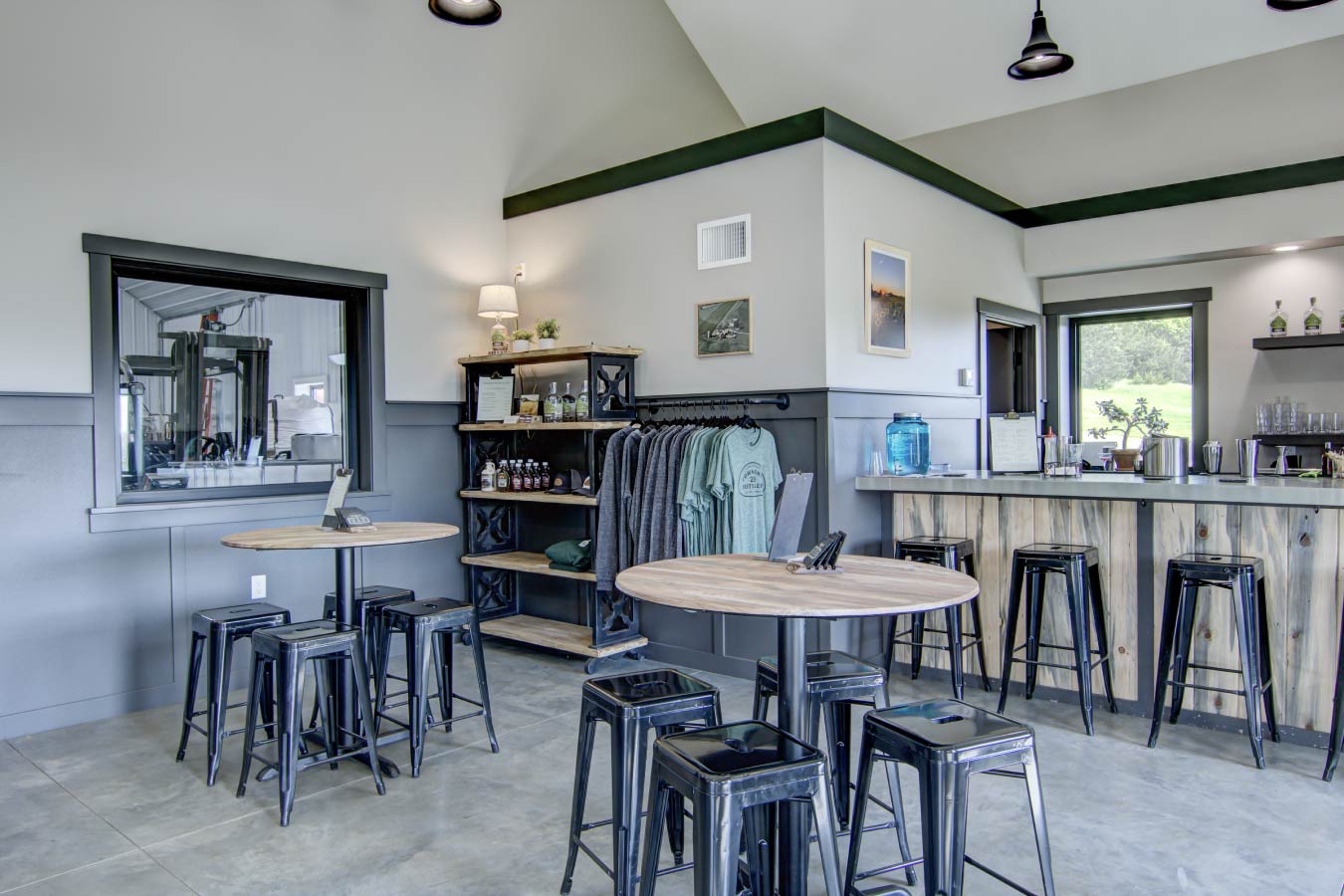 commercial building interior tasting room with seating tables polished concrete floor and large windows