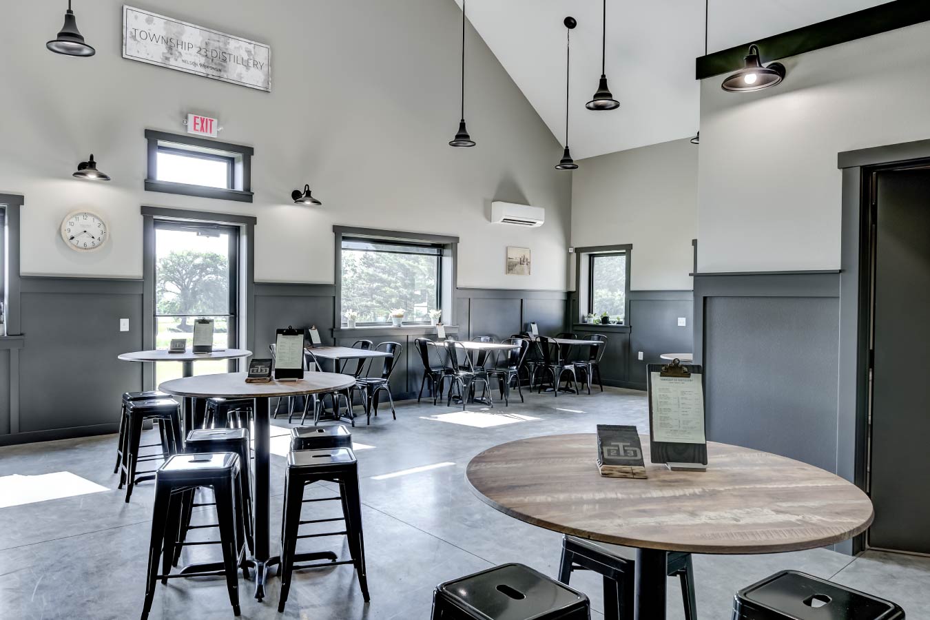 commercial building interior tasting room with bar seating merchandise display and polished concrete floors