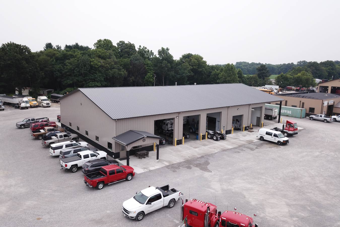 Vaughan Equipment commercial service building with trucks parked outside- 5 drive through bays