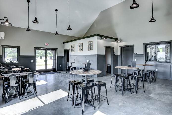 Commercial Building Interior Tasting Room with High Ceilings – Walters Buildings commercial building interior tasting room with high ceilings bar seating tables and large windows