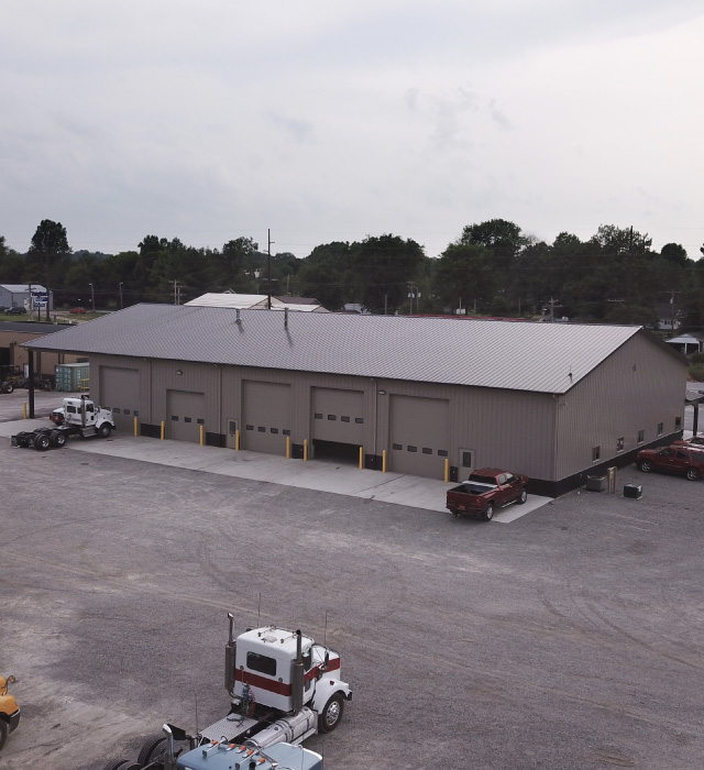 Vaughan Equipment Building – Commercial Equipment Facility in Fairfield, Illinois Vaughan Equipment Inc commercial building with large overhead service doors in Fairfield, Illinois
