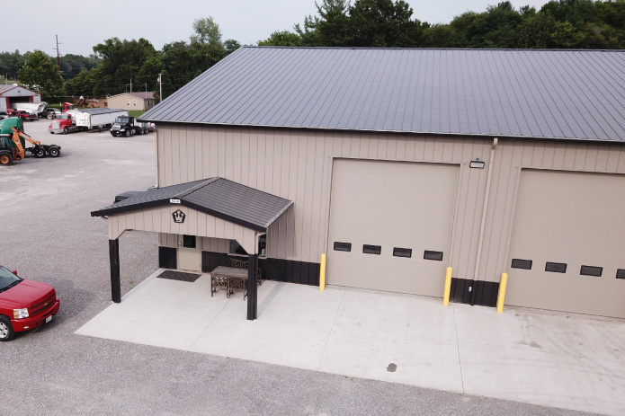 Vaughan Equipment Entrance – Commercial Equipment Service Building Custom Features of the Heavy Equipment Repair Shop Entrance to Vaughan Equipment building with covered entry and service bay Custom Features of the Heavy Equipment Repair Shop