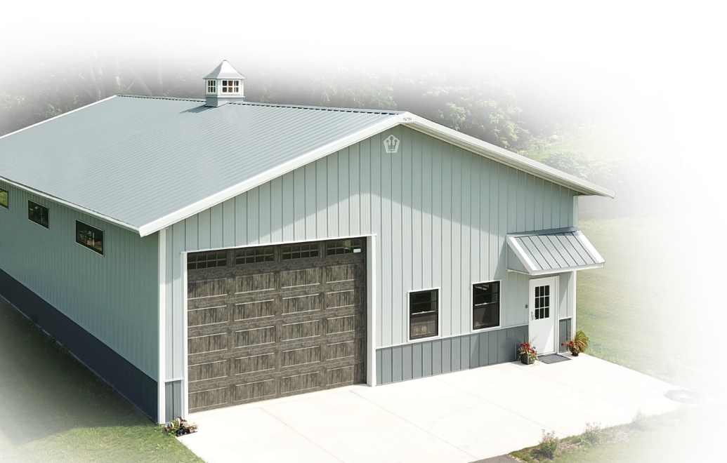 This custom post frame residential garage combines classic barn-style design with modern functionality, featuring durable red steel siding, a white overhead garage door, and a decorative cupola for added ventilation and visual appeal. Designed for homeowners seeking additional space for workshops, hobbies, or storage, this building offers a flexible interior layout with long-term durability. Ideal for rural properties and residential use, the structure provides a low-maintenance, high-performance solution that complements a variety of lifestyle needs while maintaining a clean and timeless appearance.